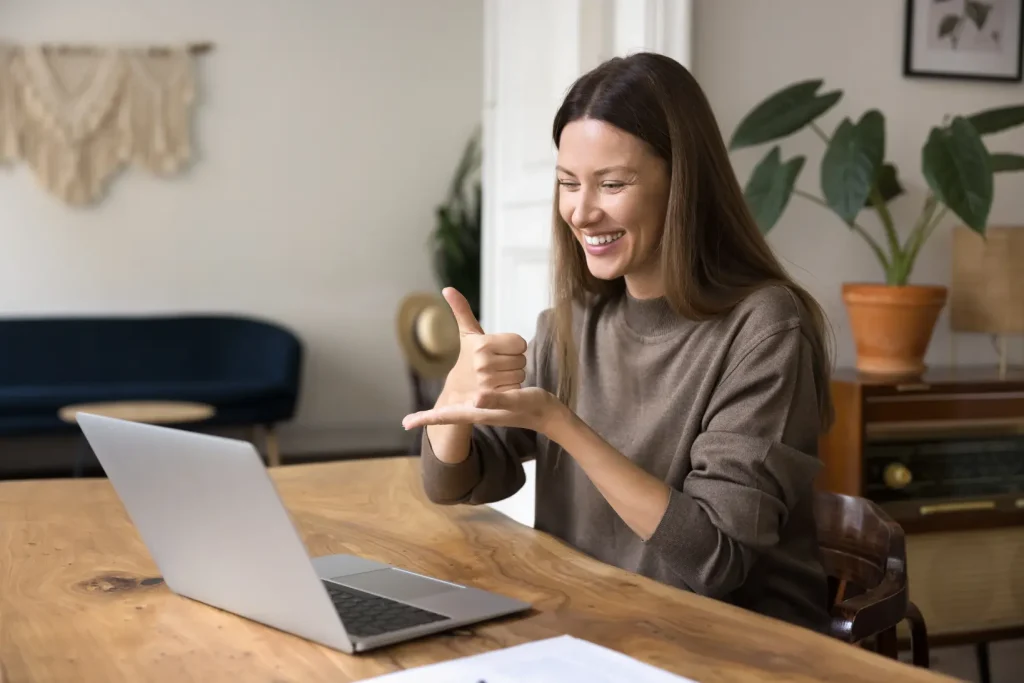 Woman using sign language over a video call with Minto Care
